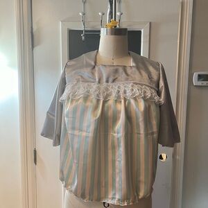 Silver/pink 3/4” sleeve blouse with ruffled lace trim.